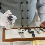 Senior man in jewelry store selling luxury watches. Expert watch repair