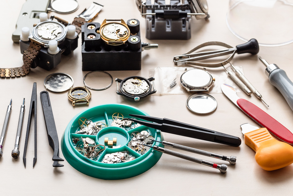 Spare watch parts on table. Watch repair service.