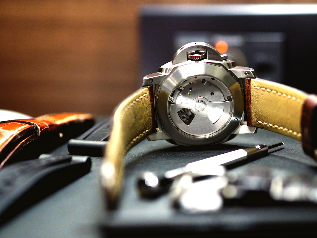 Watch showing mechanical components and leather straps. | Vintage Watch Restoration